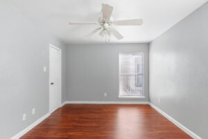 Bedrooms with wood flooring in our apartments for rent at any of the falls apartments location in Houston, TX.