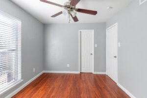 Bedrooms with wood flooring in our apartments for rent at any of the falls apartments location in Houston, TX.